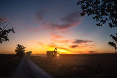 End of a harvest day on a grain field in summer with...