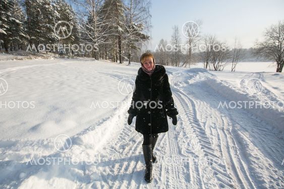 Woman in the snowy forest at winter.