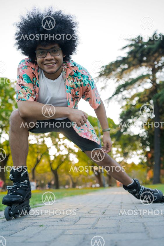 Afro Latin man rollerskating outdoors.