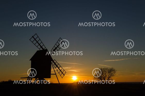 Sunset with silhouette of an old windmill