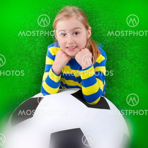 Young girl with huge soccer ball