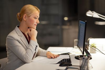 businesswoman at computer working at night office