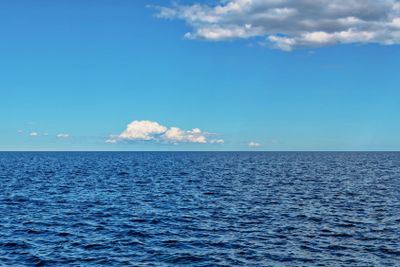 Cloud over a deep blue sea during a sunny day