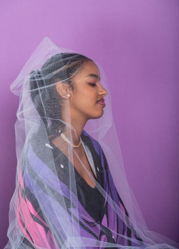 Teenage brunette girl sitting dressed in butterfly wings...