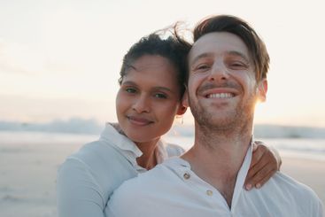 Happy couple, sunset and portrait at beach on holiday,...
