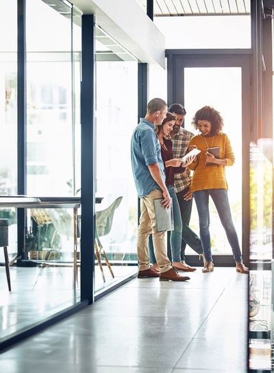 Web design, teamwork and conversation in office with...