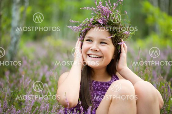 Happy girl is wearing heather wreath
