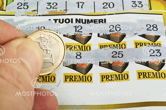 a human hand is scratching a lottery ticket