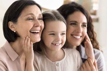 Closeup portrait little girl touch faces of grandma and...