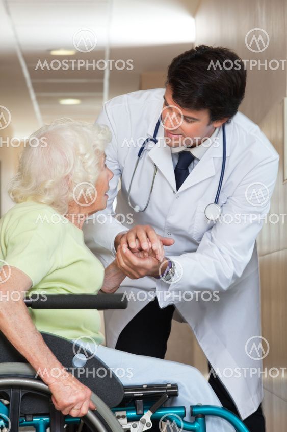 Doctor Comforting Senior Patient At Hospital