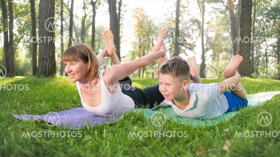 Portrait of 12 years old boy doing yoga exercise with...