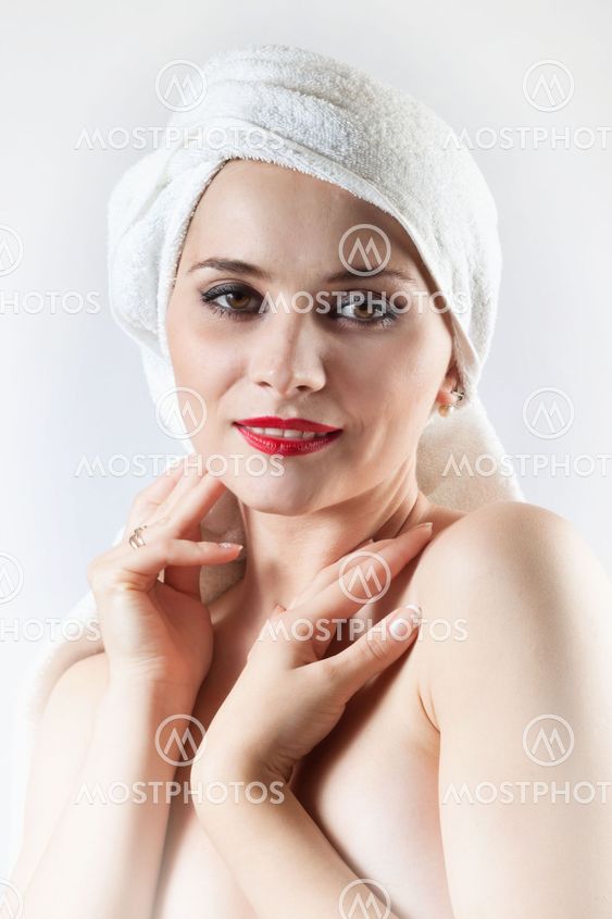 Young beautiful girl in the sauna towel