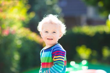Baby boy in summer garden