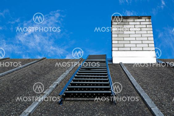 White chimney on grey roof without smoke