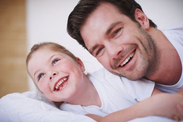 Girl, dad and laughing in home, fun and love for kid in...