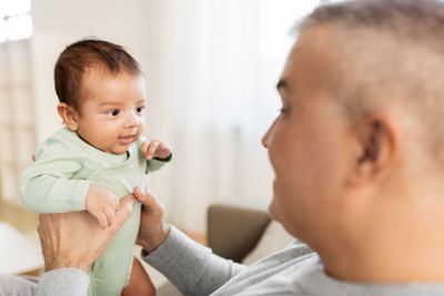 happy father with little baby boy at home