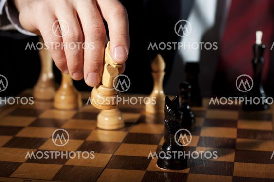 businessman plays chess