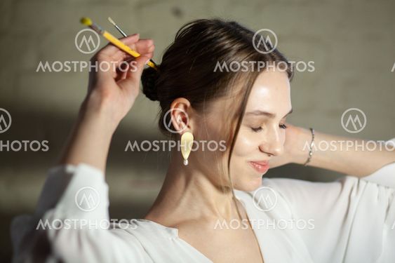 Portrait of beautiful fair young woman with jewelry, one...