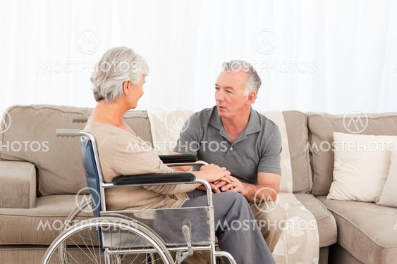 Man with his wife in a wheelchair