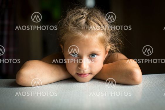 Portrait of a little girl at the table.