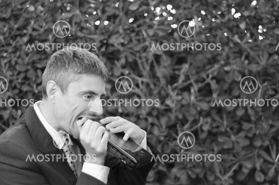 Business Man Outdoor Desperate with his Notebook