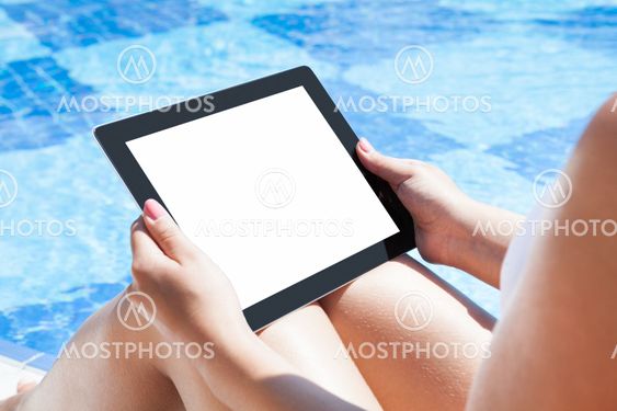 Woman Holding Digital Tablet At Poolside