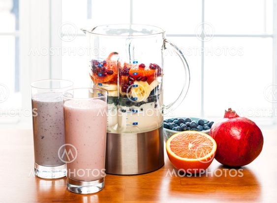 Making smoothies in blender with fruit and yogurt
