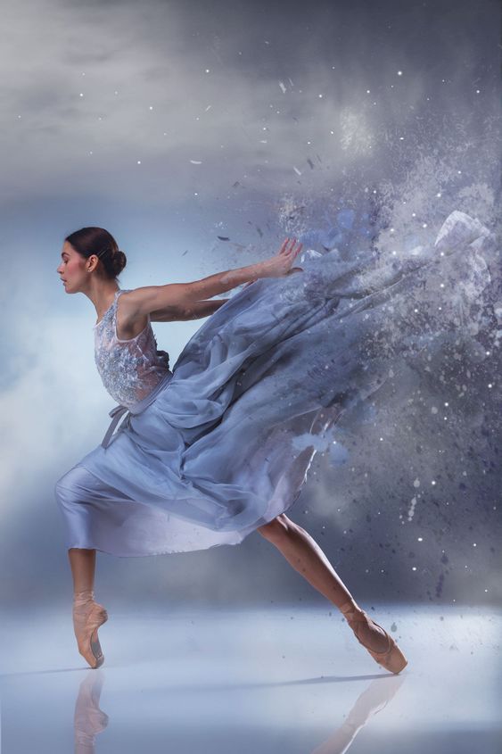 The beautiful ballerina dancing in blue long dress