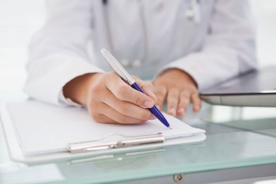 Doctor writing down medical notes