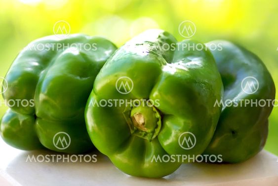 Green peppers on table.