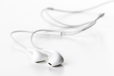 Pair of earphones close up on grey background