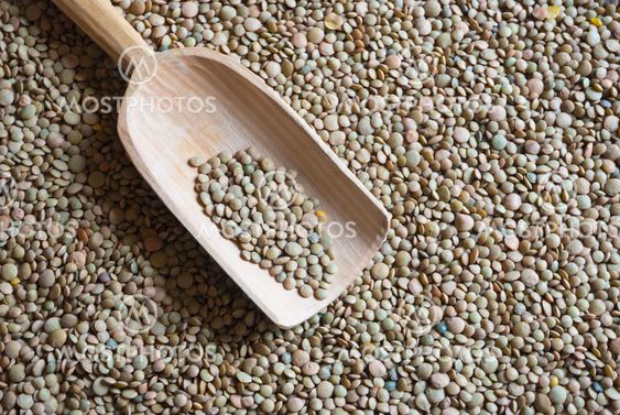 Raw lentil with wooden scooper