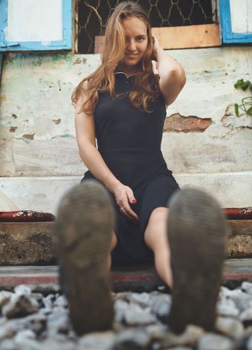 Travel, relax and portrait of woman by railway in city...