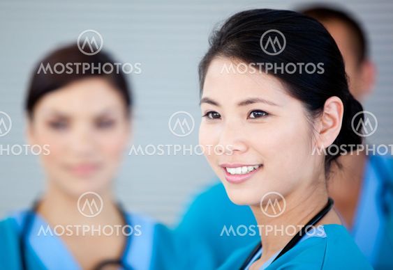 Smiling female doctor with her teamates