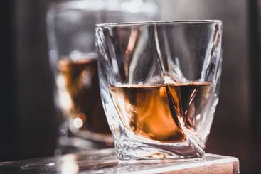 Whiskey glass in the dark close up