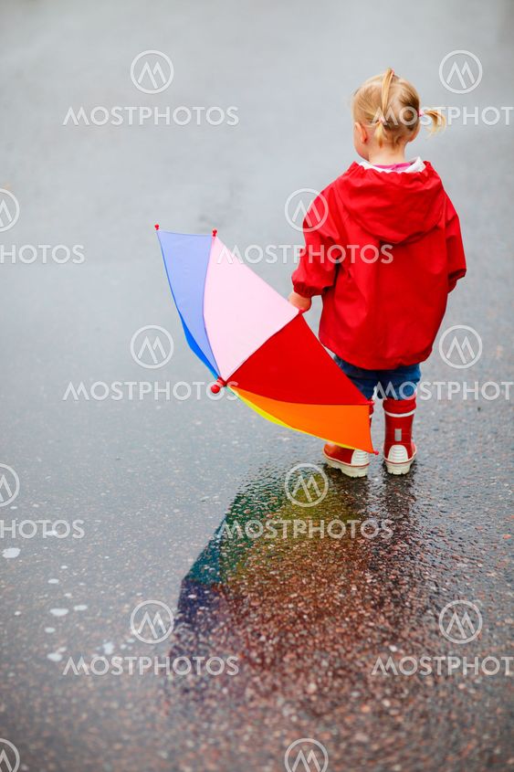Toddler girl outdoors at rainy day