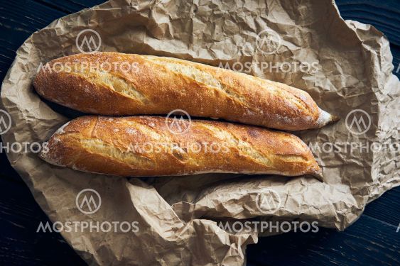 Homemade baguette bread on dark wooden table