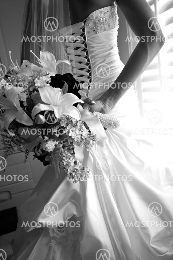 Bride dressing for the wedding ceremony
