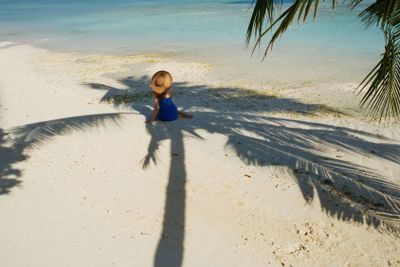 Woman in blue dress on a beach at Maldives
