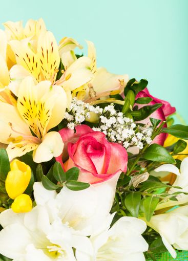 Beautiful floral arrangement featuring vibrant roses and...