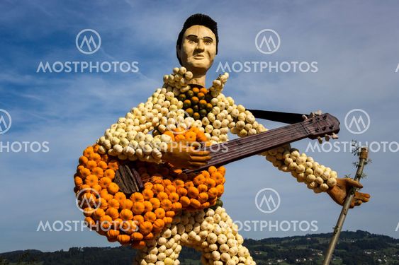 Farm art guitar and guitarist made of small orange, green and white pumpkins