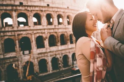 Loving couple in front of the Colosseum in Rome