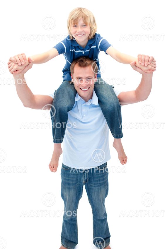 Smiling father giving his son piggyback ride