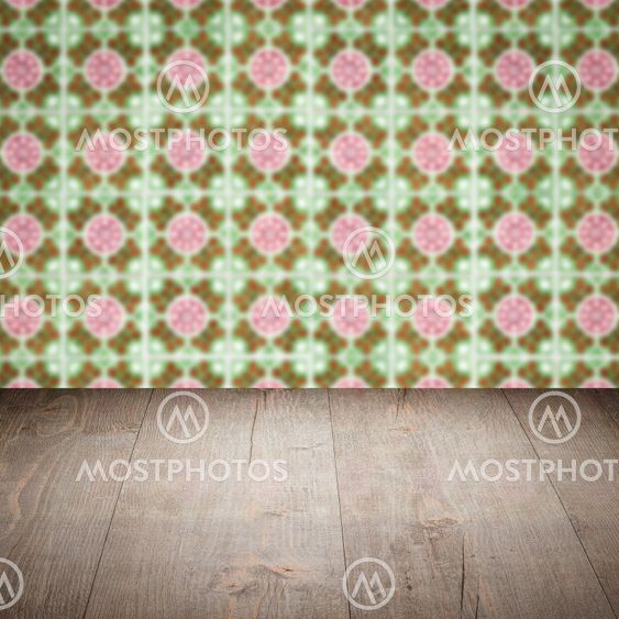 Wood table top and blur vintage ceramic tile pattern wall