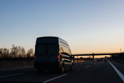 Van silhouette driving at dusk on European highway German...