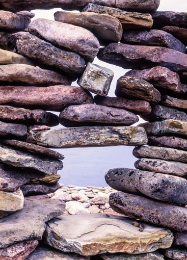 View at the sea through a stone wall at a beach