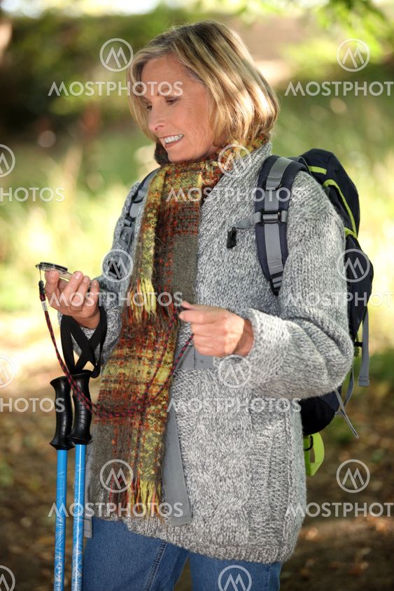Hiker using a compass in the woods