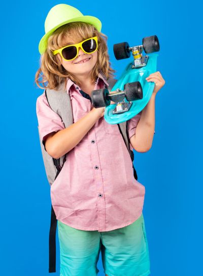 Childhood. Cute child with skateboard on color isoalted...