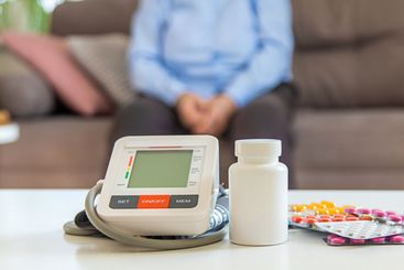 An old woman measures her blood pressure. Selective focus.
