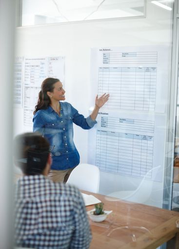 Presentation, poster and businesswoman in meeting in...